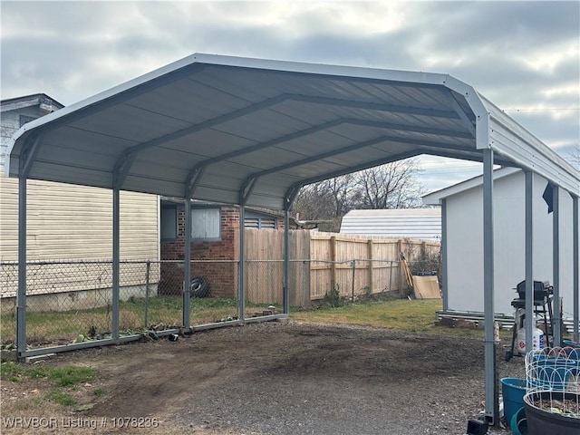 404 Loy Ave, Arkoma, OK 74901 - view of parking with fence and a detached carport