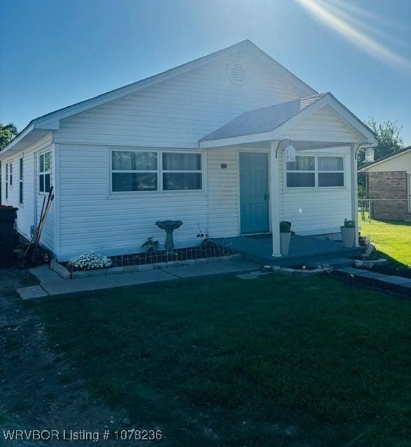 404 Loy Ave, Arkoma, OK 74901 - view of front of home featuring a front lawn and fence