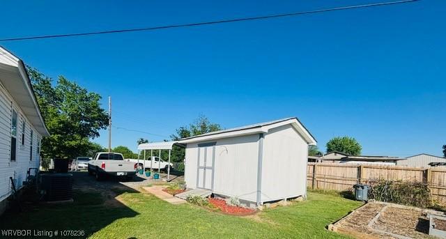 404 Loy Ave, Arkoma, OK 74901 - view of shed with cooling unit, a vegetable garden, and fence