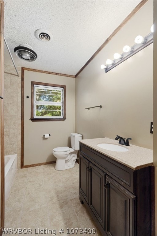 full bathroom with a textured ceiling, vanity, tiled shower / bath combo, crown molding, and toilet