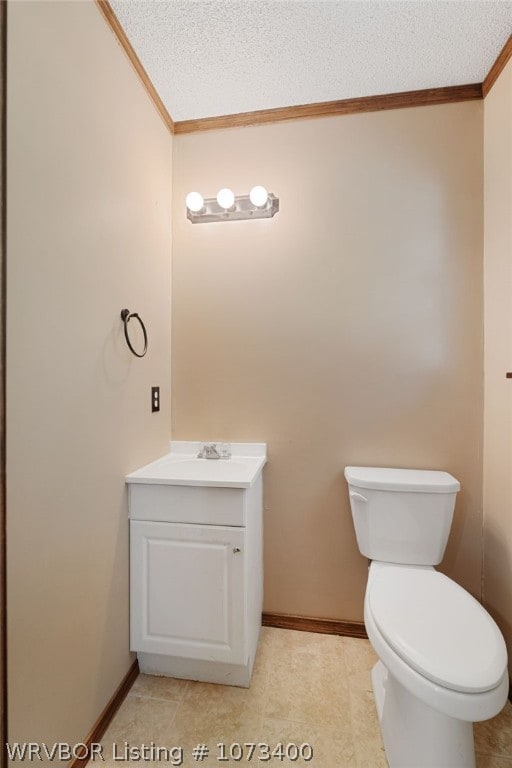 bathroom with crown molding, vanity, a textured ceiling, and toilet