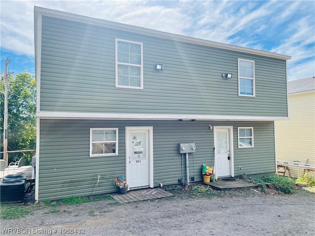 back of house with central AC unit