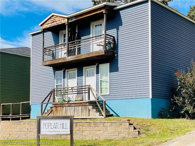 view of front of house with a balcony