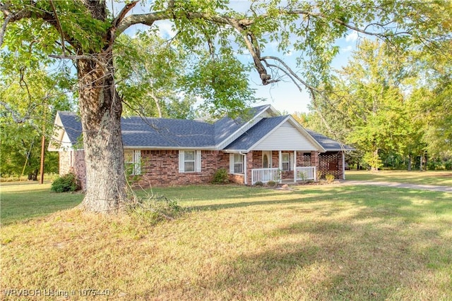 single story home featuring covered porch and a front lawn