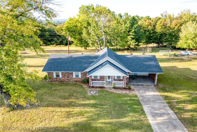 view of front of house with a front lawn, covered porch, and a carport