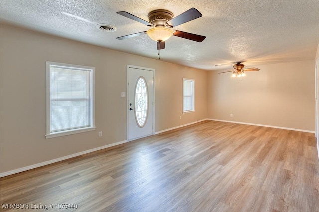 entrance foyer with a textured ceiling, light hardwood / wood-style flooring, and ceiling fan