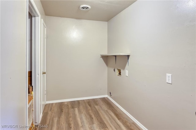 laundry room featuring washer hookup and light wood-type flooring