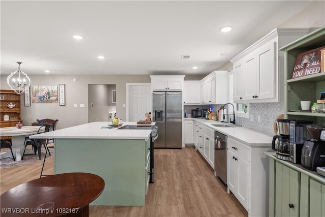 14008 White Bluff Rd, Fort Smith, AR 72916 - kitchen with appliances with stainless steel finishes, light wood-style flooring, an island with sink, white cabinets, and recessed lighting