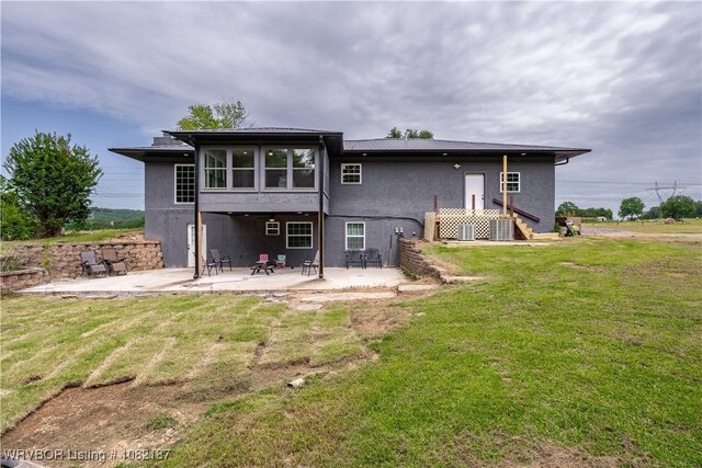 14008 White Bluff Rd, Fort Smith, AR 72916 - rear view of house with stucco siding, a patio, and a yard