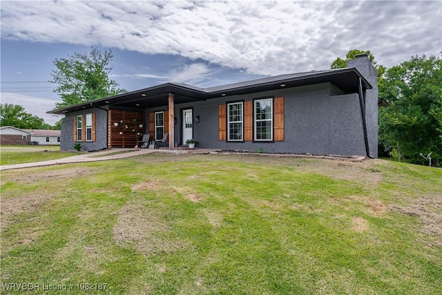 14008 White Bluff Rd, Fort Smith, AR 72916 - view of front of property with a front yard, a chimney, and stucco siding