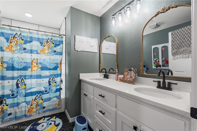14008 White Bluff Rd, Fort Smith, AR 72916 - bathroom featuring a textured wall, double vanity, and tile patterned floors