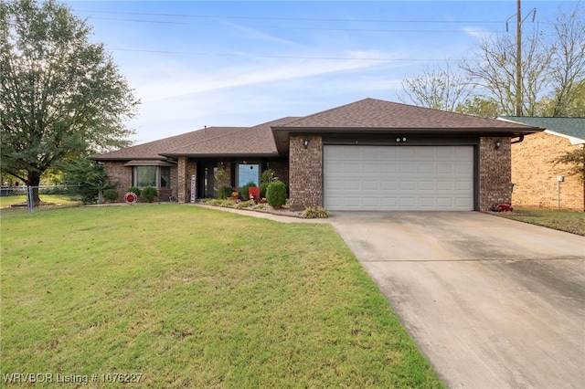 view of front facade with a garage and a front lawn