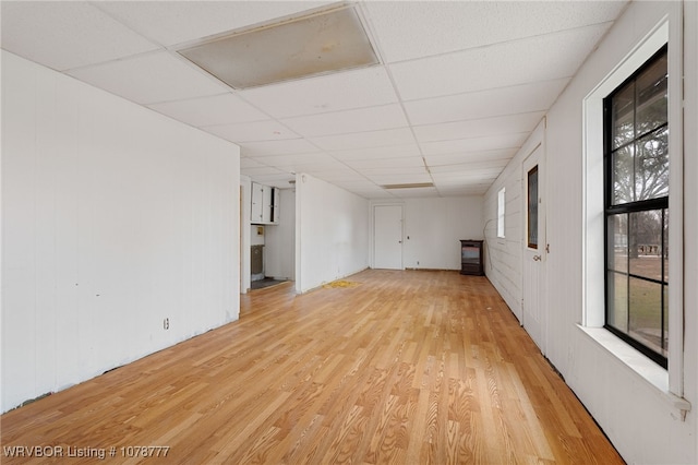 unfurnished room featuring a drop ceiling and light hardwood / wood-style flooring