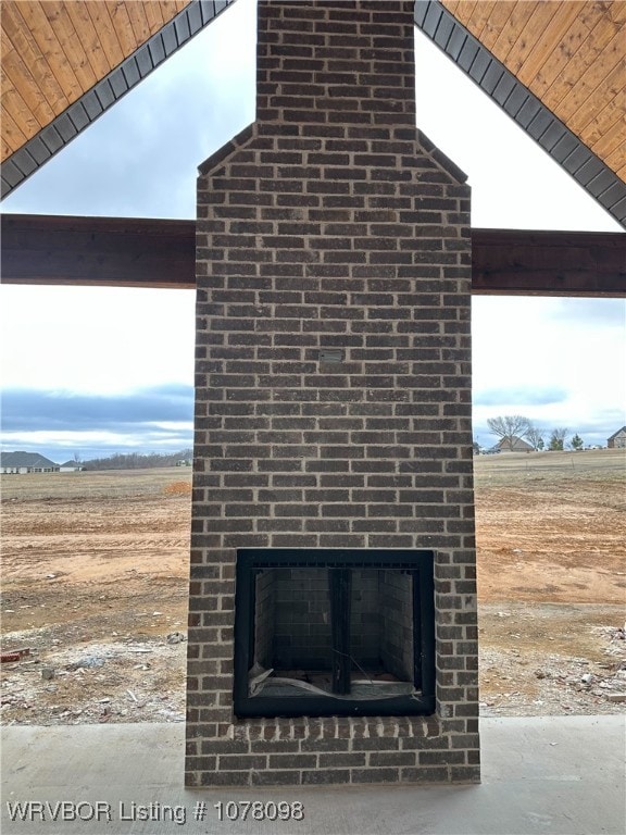 details featuring an outdoor brick fireplace