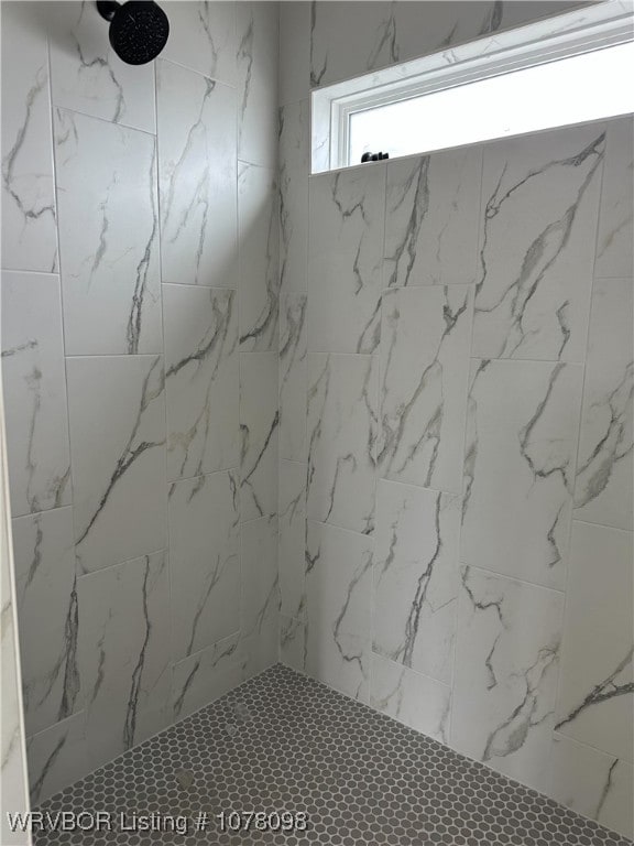 bathroom with a tile shower