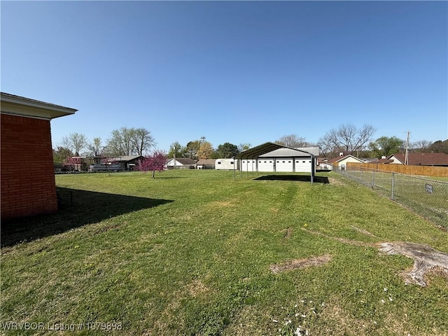view of yard featuring a detached carport and fence