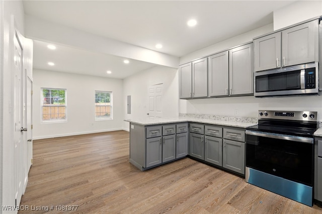 925 Cedar St, Van Buren, AR 72956 - kitchen with appliances with stainless steel finishes, gray cabinetry, a peninsula, light wood-style flooring, and recessed lighting