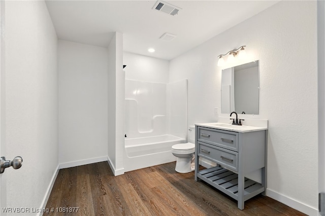 925 Cedar St, Van Buren, AR 72956 - bathroom featuring vanity, toilet, wood finished floors, shower / washtub combination, and baseboards