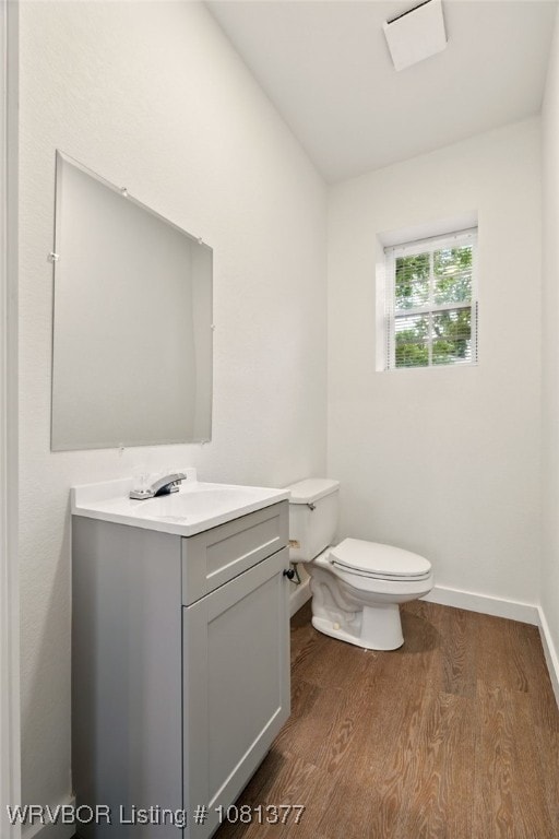 925 Cedar St, Van Buren, AR 72956 - bathroom featuring toilet, vanity, wood finished floors, and baseboards