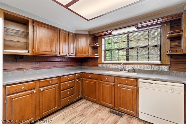 kitchen with dishwasher, light hardwood / wood-style flooring, and sink