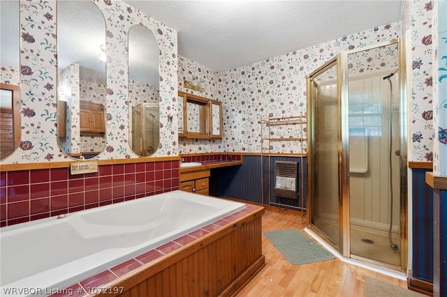 bathroom with plus walk in shower, hardwood / wood-style floors, a textured ceiling, and vanity