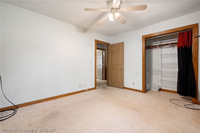 unfurnished bedroom featuring ceiling fan, a closet, and light colored carpet