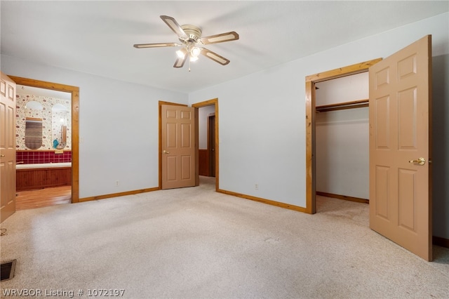 unfurnished bedroom with connected bathroom, ceiling fan, a closet, and light colored carpet