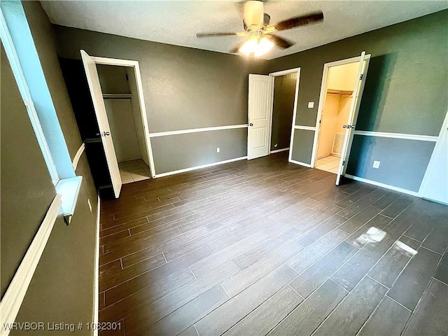 9423 Gate Nine Cutoff, Fort Smith, AR 72916 - unfurnished bedroom featuring dark wood finished floors, a textured ceiling, and ceiling fan