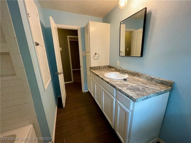 9423 Gate Nine Cutoff, Fort Smith, AR 72916 - full bathroom with vanity, a textured ceiling, and wood finished floors