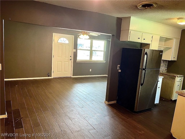 9423 Gate Nine Cutoff, Fort Smith, AR 72916 - kitchen with freestanding refrigerator, dark wood-style floors, a ceiling fan, white cabinetry, and a textured ceiling