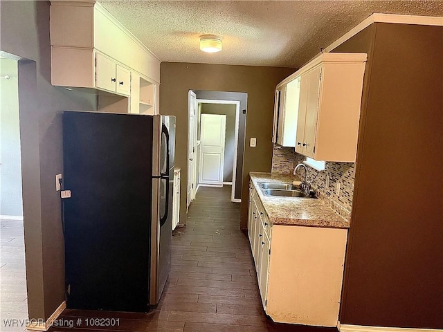 9423 Gate Nine Cutoff, Fort Smith, AR 72916 - kitchen featuring freestanding refrigerator, dark wood-style floors, decorative backsplash, white cabinets, and a textured ceiling