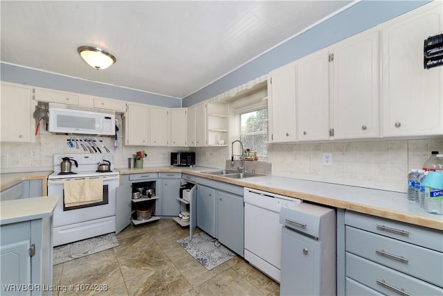 kitchen with sink, white cabinets, and white appliances