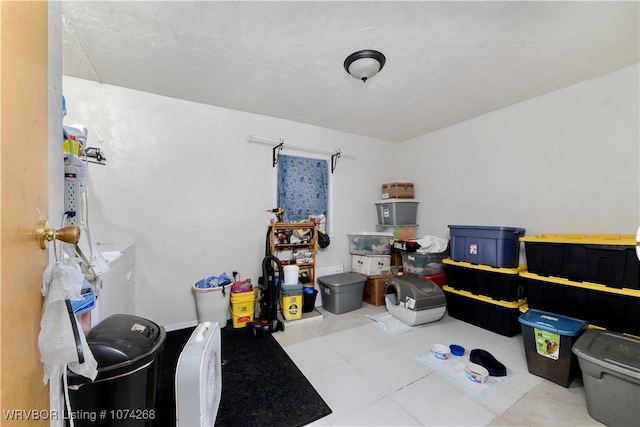 interior space with light tile patterned floors and washer / dryer