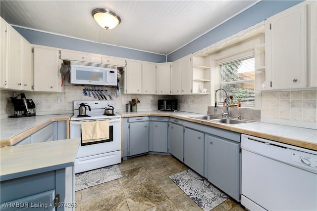 kitchen featuring white appliances, sink, decorative backsplash, gray cabinets, and white cabinetry