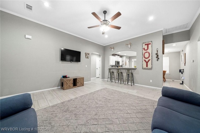 living room featuring ceiling fan and ornamental molding