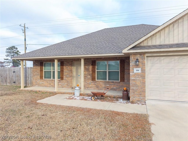 ranch-style home with covered porch and a garage