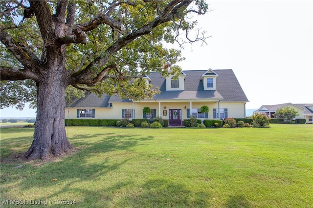 new england style home with a front yard and a porch