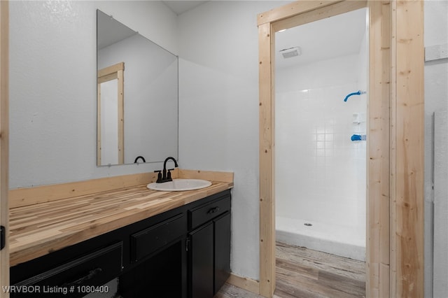 1703 E Edmondson Dr, Sallisaw, OK 74955 - full bath featuring a stall shower, vanity, and wood finished floors