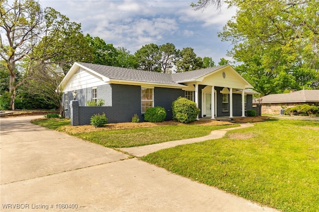 1703 E Edmondson Dr, Sallisaw, OK 74955 - view of front of home with a front lawn, a porch, brick siding, concrete driveway, and a shingled roof