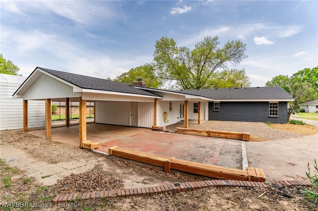 1703 E Edmondson Dr, Sallisaw, OK 74955 - modern farmhouse style home with an attached carport, a chimney, and brick siding