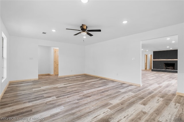 1703 E Edmondson Dr, Sallisaw, OK 74955 - unfurnished living room featuring ceiling fan, light wood-type flooring, recessed lighting, baseboards, and a fireplace