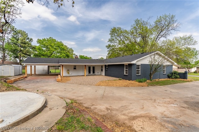 1703 E Edmondson Dr, Sallisaw, OK 74955 - ranch-style house featuring concrete driveway, french doors, and a chimney