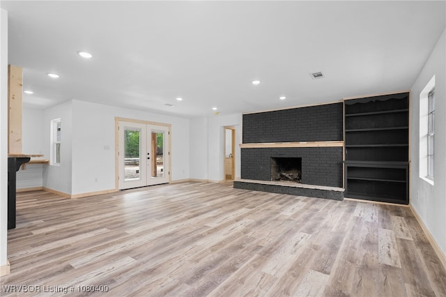 1703 E Edmondson Dr, Sallisaw, OK 74955 - unfurnished living room with baseboards, wood finished floors, recessed lighting, a fireplace, and french doors