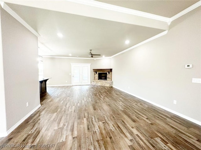 2060 W Breckenridge St, Sallisaw, OK 74955 - unfurnished living room featuring a brick fireplace, ceiling fan, wood finished floors, ornamental molding, and recessed lighting