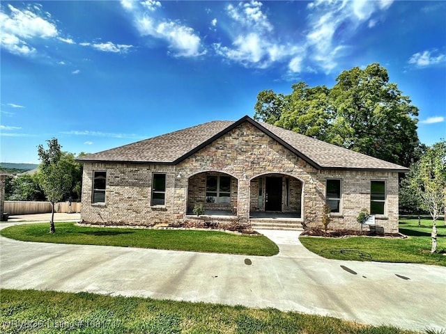 2060 W Breckenridge St, Sallisaw, OK 74955 - view of front of home featuring a porch, brick siding, and roof with shingles