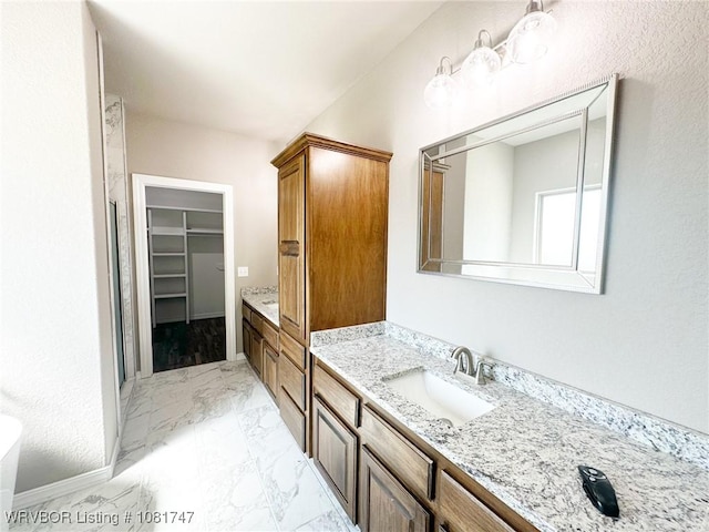 2060 W Breckenridge St, Sallisaw, OK 74955 - full bathroom with vanity, marble look tiles, a walk in closet, and a shower stall