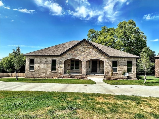 2060 W Breckenridge St, Sallisaw, OK 74955 - french country inspired facade featuring covered porch, brick siding, and a shingled roof
