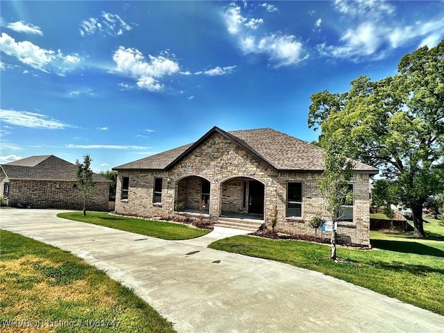2060 W Breckenridge St, Sallisaw, OK 74955 - french country inspired facade with a front yard, brick siding, a porch, and roof with shingles