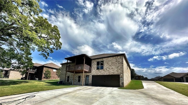 2060 W Breckenridge St, Sallisaw, OK 74955 - view of front of property with concrete driveway, stone siding, an attached garage, a balcony, and a front lawn