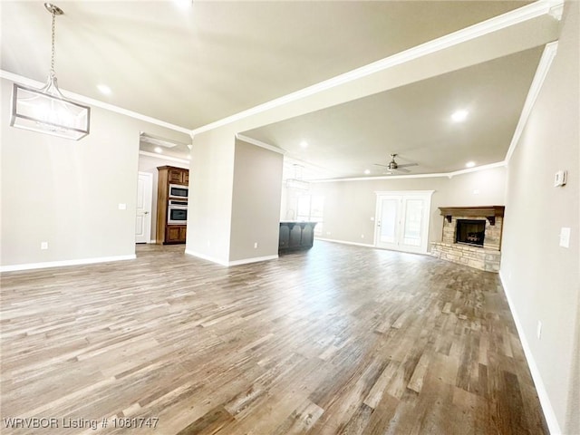 2060 W Breckenridge St, Sallisaw, OK 74955 - unfurnished living room with a fireplace, light wood-type flooring, ceiling fan, crown molding, and recessed lighting